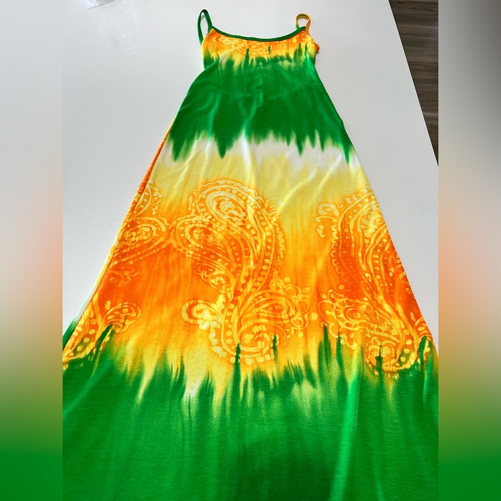 This beautiful dress is long and fitted, it’s green, orange and yellow.